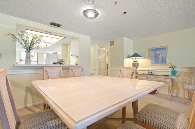 5740 Midnight Pass Rd Unit 402, Sarasota, FL 34242 - dining room with a textured ceiling, baseboards, visible vents, and light colored carpet