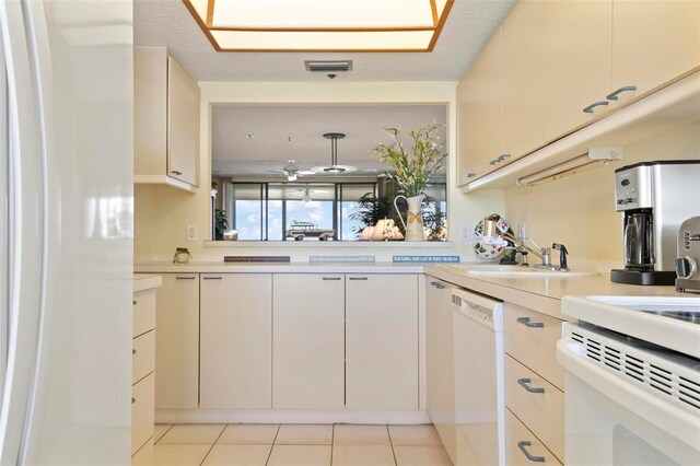5740 Midnight Pass Rd Unit 402, Sarasota, FL 34242 - kitchen featuring light tile patterned floors, light countertops, white appliances, and visible vents