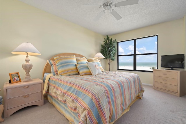 5740 Midnight Pass Rd Unit 402, Sarasota, FL 34242 - bedroom featuring a ceiling fan, light carpet, and a textured ceiling