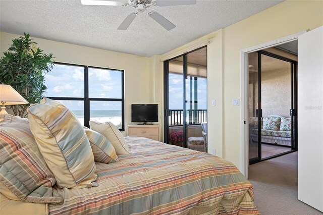 5740 Midnight Pass Rd Unit 402, Sarasota, FL 34242 - bedroom with a ceiling fan, access to outside, a textured ceiling, and carpet