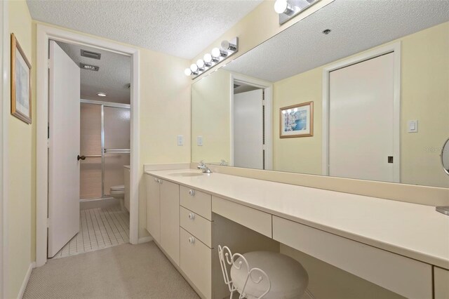 5740 Midnight Pass Rd Unit 402, Sarasota, FL 34242 - bathroom with visible vents, toilet, a stall shower, a textured ceiling, and vanity