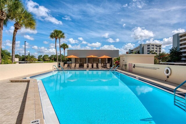5740 Midnight Pass Rd Unit 402, Sarasota, FL 34242 - pool featuring a patio area and fence