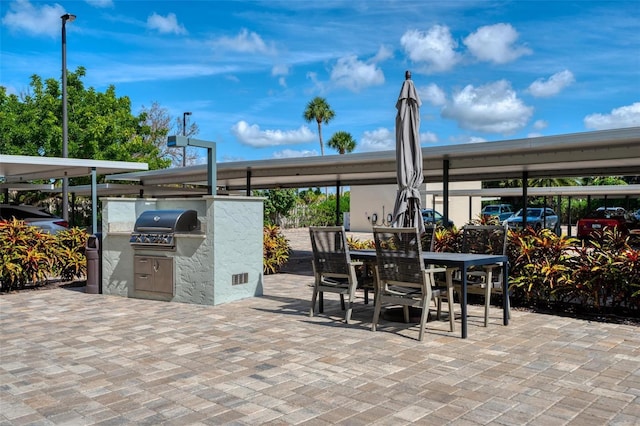 5740 Midnight Pass Rd Unit 402, Sarasota, FL 34242 - view of patio with exterior kitchen, outdoor dining space, and a grill