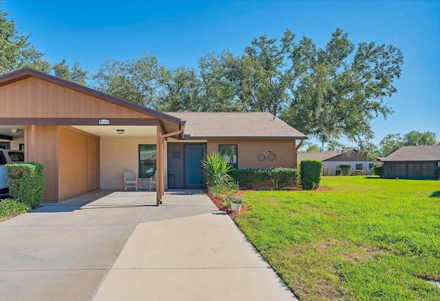 view of front of house with a front yard and stucco siding