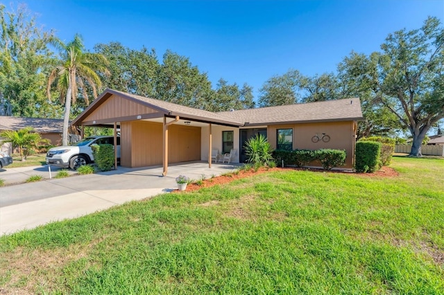 single story home with a carport, a front yard, and concrete driveway