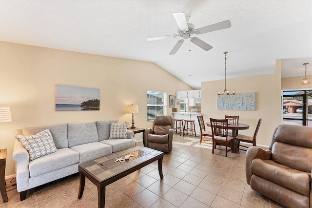 living room with lofted ceiling, a textured ceiling, and light tile patterned floors