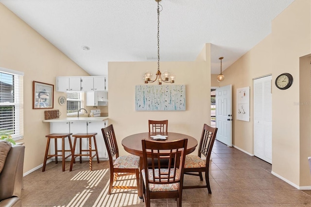 tiled dining space with baseboards, vaulted ceiling, a textured ceiling, and a chandelier