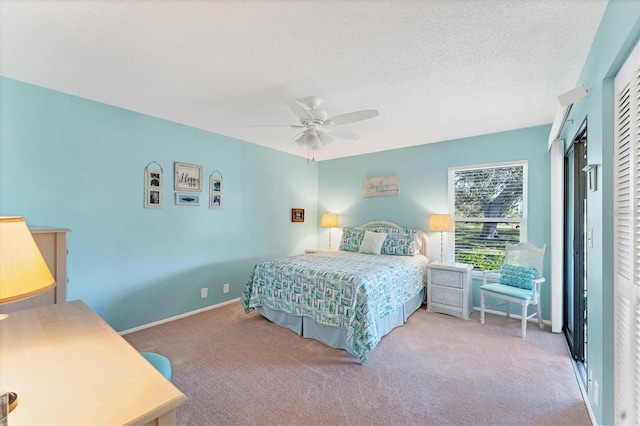 bedroom with carpet, a closet, a ceiling fan, a textured ceiling, and baseboards