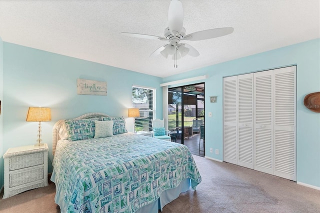 carpeted bedroom featuring access to exterior, ceiling fan, a textured ceiling, and baseboards