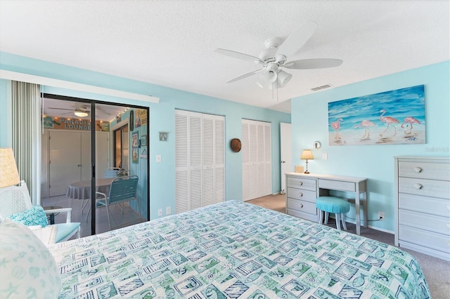 bedroom with a textured ceiling, carpet flooring, visible vents, multiple closets, and access to outside