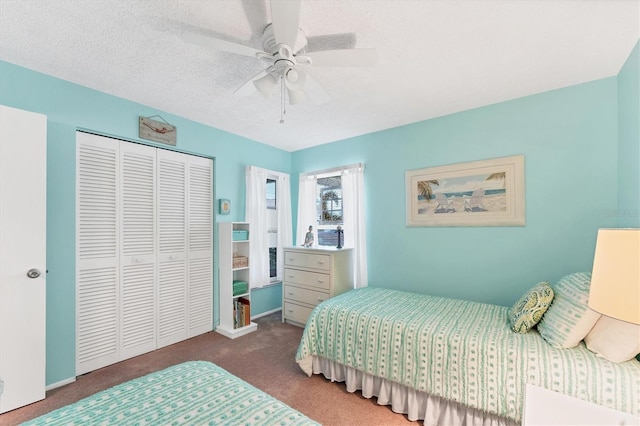 carpeted bedroom with a textured ceiling, a closet, and a ceiling fan