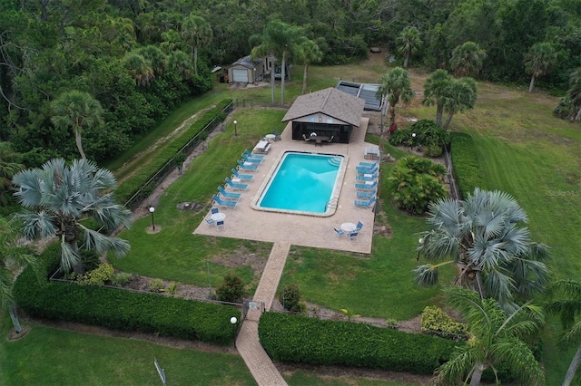 view of pool featuring a yard and fence