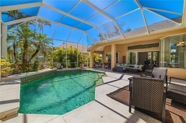 outdoor pool featuring a lanai, a patio area, ceiling fan, and outdoor lounge area