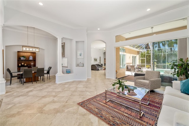 living area featuring baseboards, recessed lighting, decorative columns, and crown molding