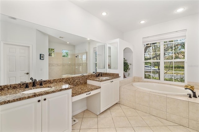 full bathroom with a bath, tile patterned flooring, plenty of natural light, and tiled shower