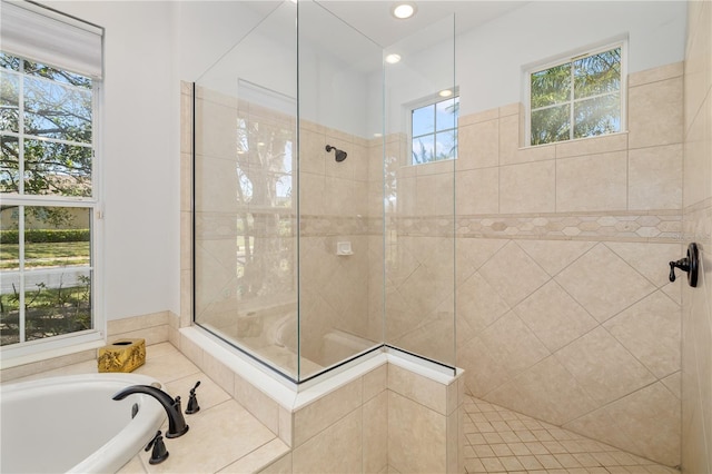 bathroom with a washtub and a walk in shower