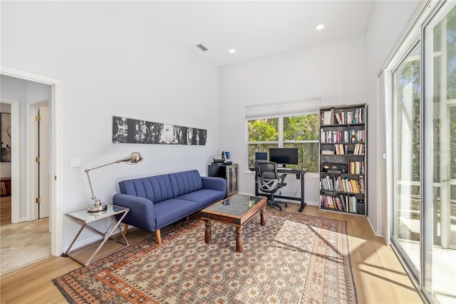 living area featuring light wood-style flooring, visible vents, and recessed lighting