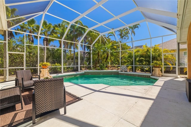 outdoor pool with a patio area and glass enclosure