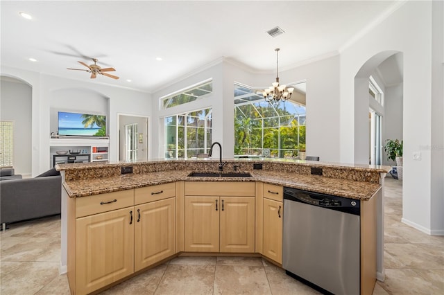 kitchen featuring dishwasher, open floor plan, stone countertops, and a sink