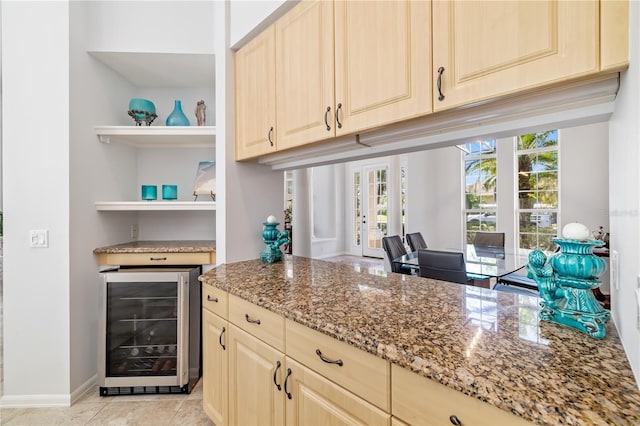 kitchen featuring light tile patterned floors, baseboards, wine cooler, light stone countertops, and open shelves