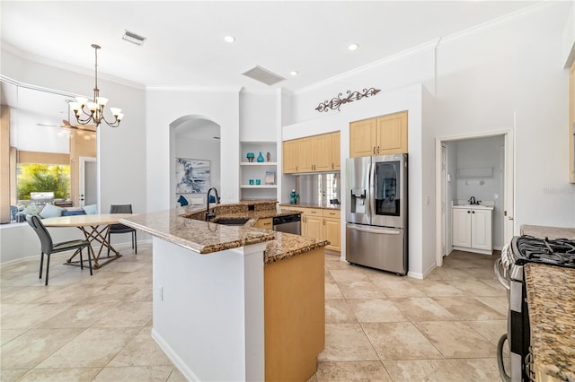 kitchen with appliances with stainless steel finishes, visible vents, a sink, and light brown cabinetry