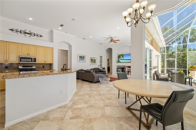 dining space with arched walkways, light tile patterned floors, recessed lighting, ceiling fan with notable chandelier, and ornamental molding