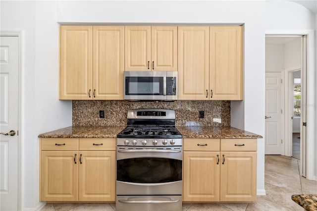 kitchen featuring light brown cabinets, appliances with stainless steel finishes, and decorative backsplash