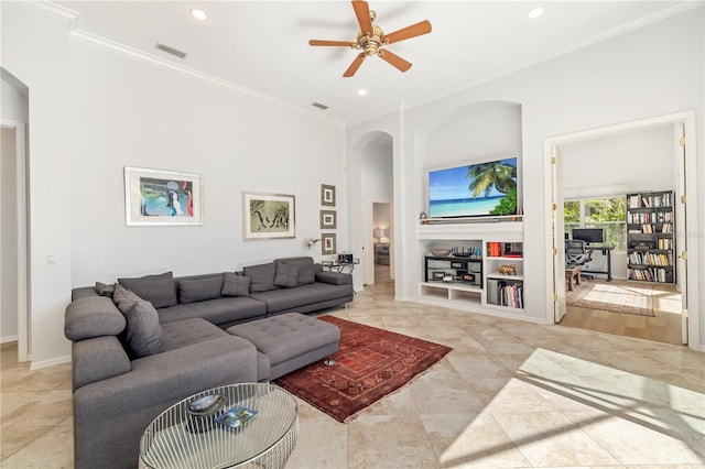 living room with arched walkways, visible vents, crown molding, and recessed lighting