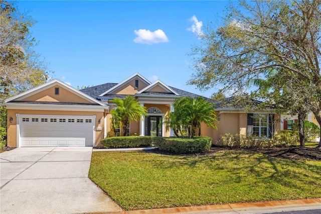 single story home featuring a garage, driveway, a front lawn, and stucco siding