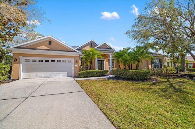 view of front of property with a garage, driveway, a front yard, and stucco siding