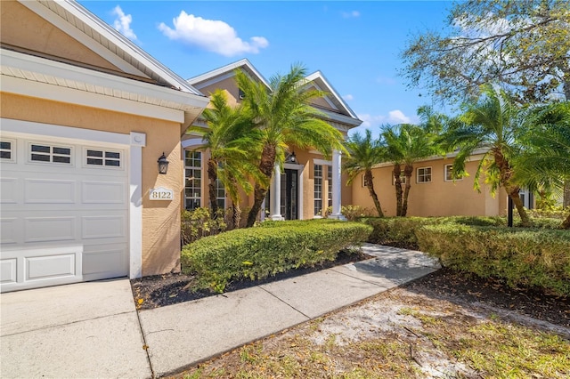 view of front of home with an attached garage and stucco siding