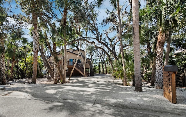 view of street with driveway and stairs