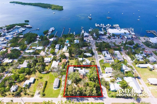 birds eye view of property featuring a water view and a residential view