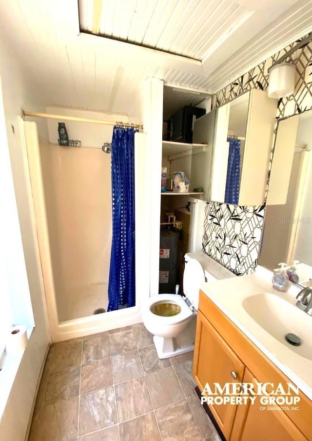 full bathroom with toilet, a stall shower, and vanity