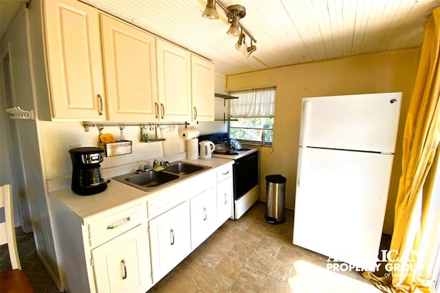 kitchen with range with electric cooktop, a sink, wood ceiling, light countertops, and freestanding refrigerator