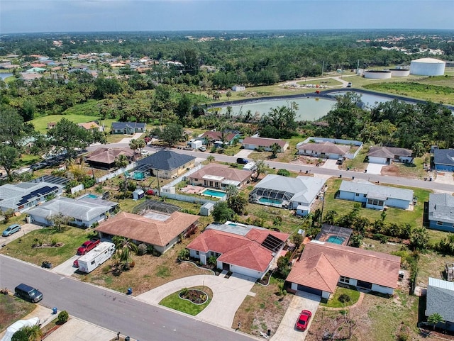 drone / aerial view with a residential view and a water view