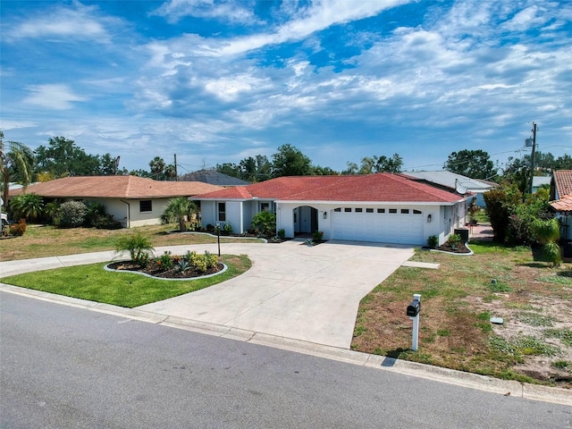 view of front of house featuring a front lawn, concrete driveway, an attached garage, and stucco siding