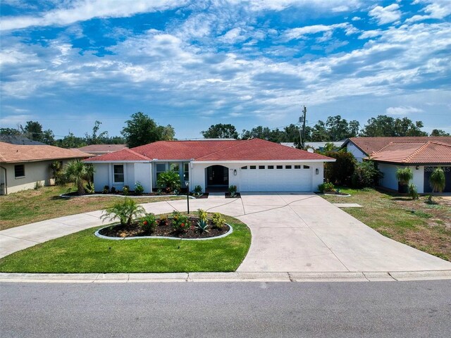 single story home with driveway, an attached garage, a front lawn, and stucco siding