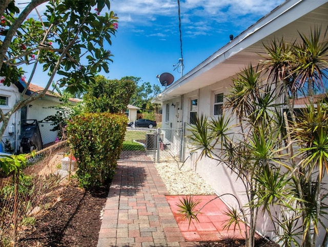 view of patio featuring fence and a gate