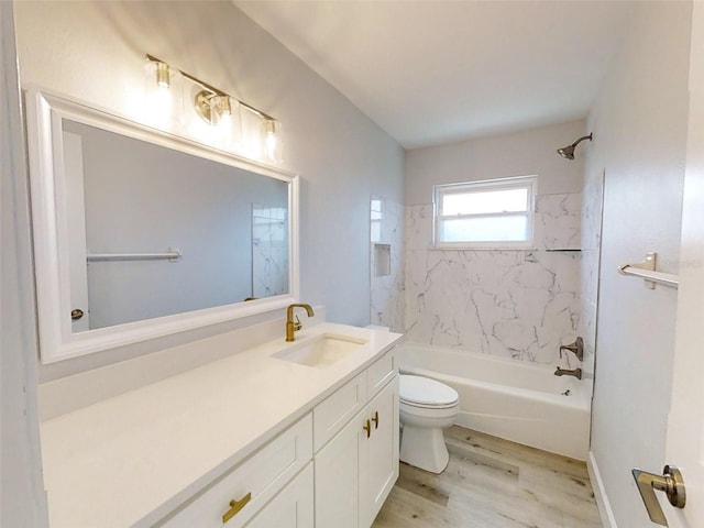 full bath featuring vanity, tub / shower combination, wood finished floors, and toilet