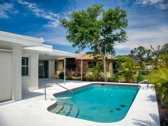 outdoor pool featuring fence and a patio