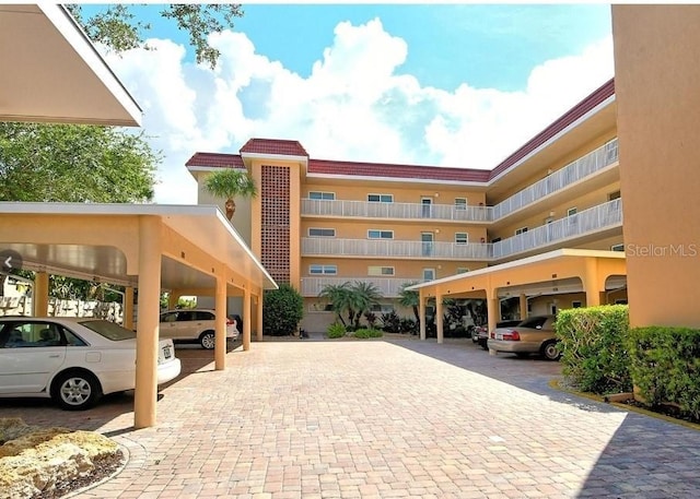 view of building exterior with covered parking