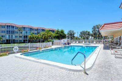 pool with fence and a patio