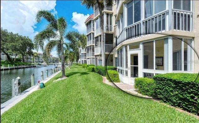 exterior space with a lawn and a water view