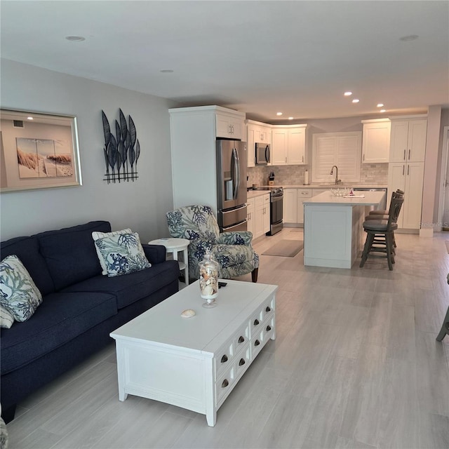 living area featuring recessed lighting and light wood-style floors