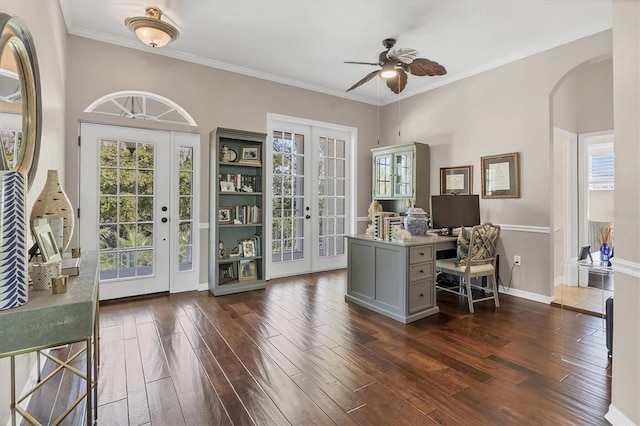 unfurnished office featuring dark wood-style floors, arched walkways, french doors, and crown molding