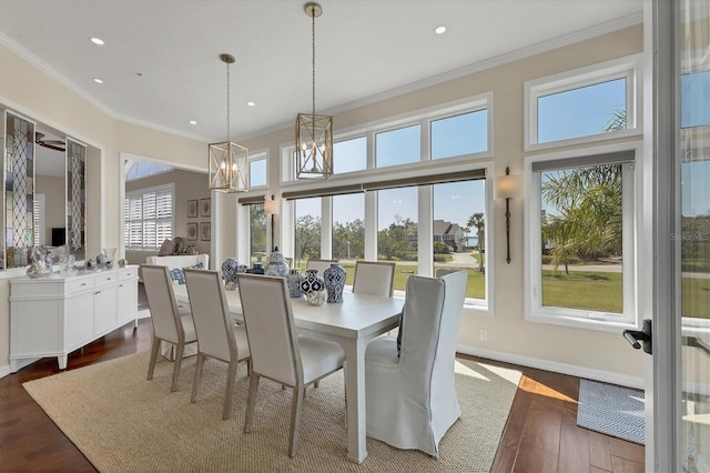 dining room featuring dark wood-style floors, recessed lighting, crown molding, and baseboards