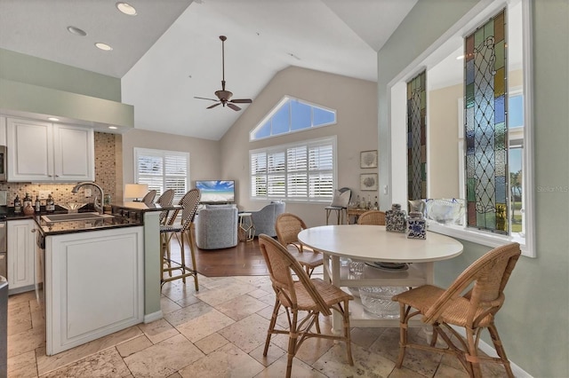 dining room featuring stone tile floors, baseboards, ceiling fan, and recessed lighting