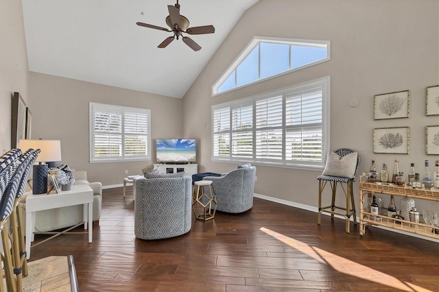 living area with ceiling fan, plenty of natural light, baseboards, and wood finished floors