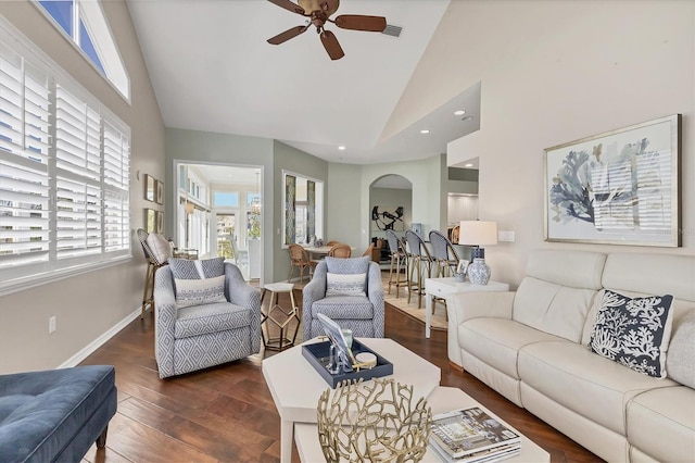 living area featuring visible vents, dark wood-type flooring, ceiling fan, high vaulted ceiling, and baseboards